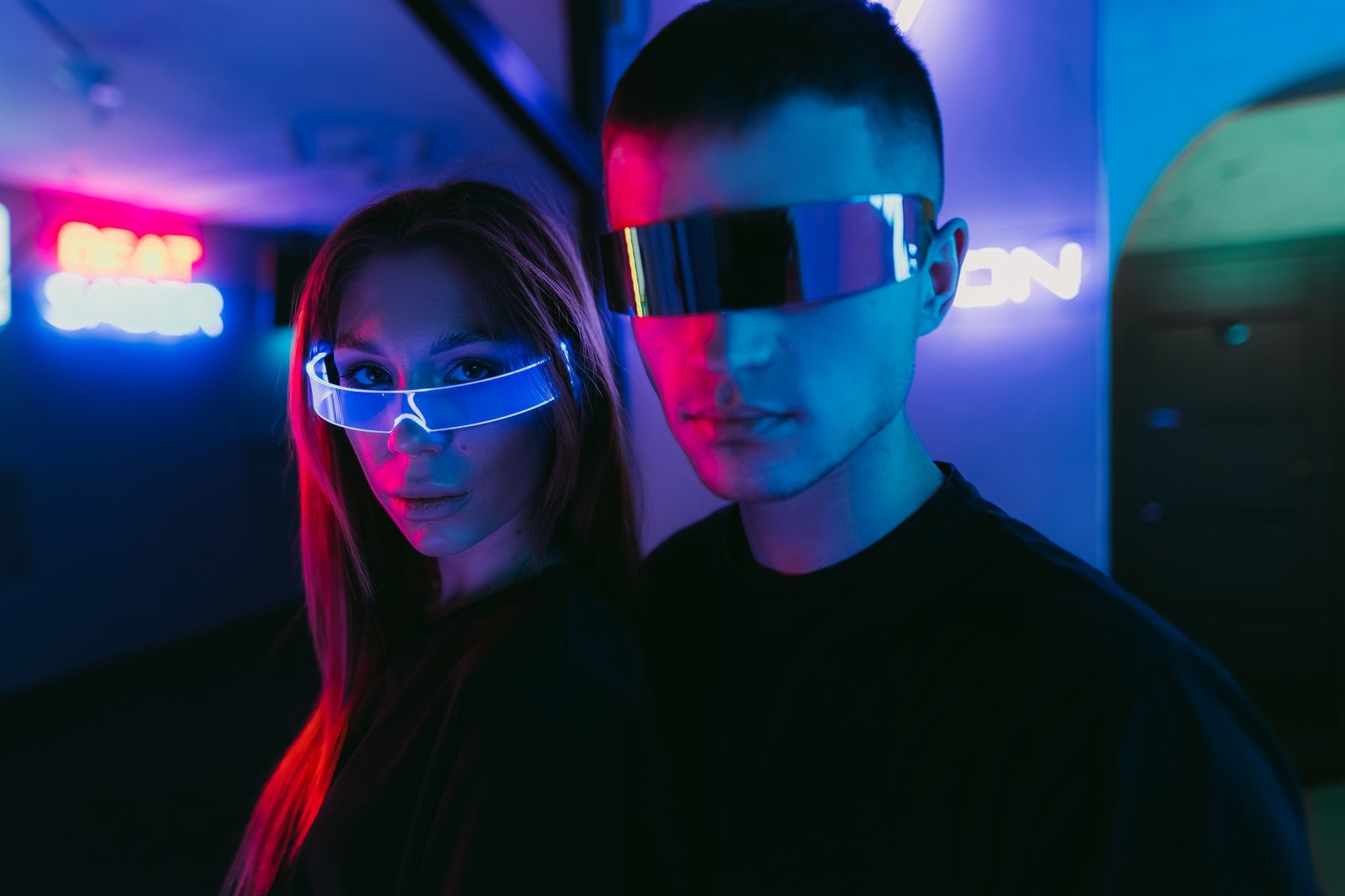 Man and woman in futuristic style. Neon noir